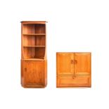 An Ercol golden dawn light elm free standing corner cupboard with an open upper section above a