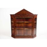 A 19th-century Dutch mahogany and marquetry single door hanging display cabinet with canted angles