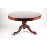 A Victorian mahogany circular flip-top breakfast table. With a carved tripod base. 120 cm diameter x