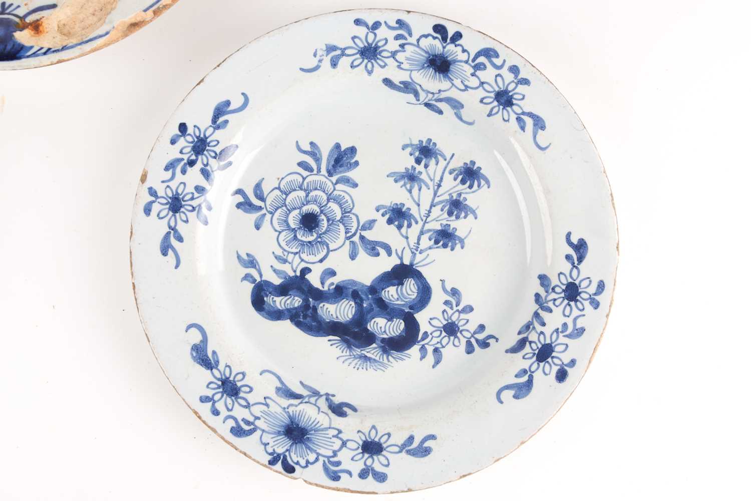 An 18th century delftware bowl and three plates, the bowl and a plate similarly decorated, painted - Image 2 of 7