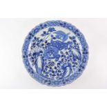 A large Japanese Meiji period scallop-edged circular blue and white porcelain charger. Painted