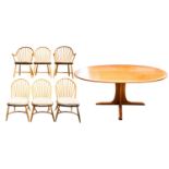 An Ercol golden dawn light elm oval dining table and six "Windsor" style dining chairs comprising