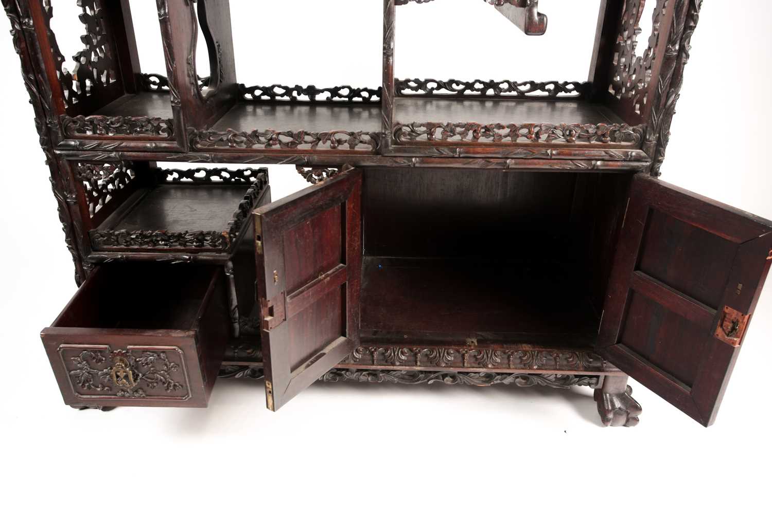 A Chinese hongmu open cabinet, early 20th century, carved throughout with Dogs of Fo, fruiting - Image 2 of 22