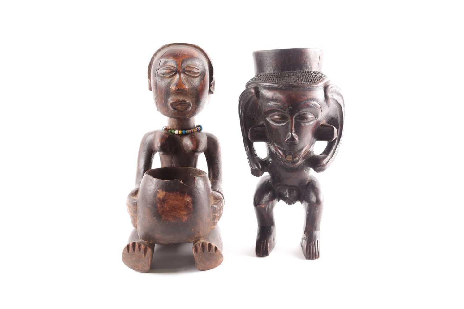 A Luba seated female divination figure, Mboko, Democratic Republic of Congo, seated holding bowl