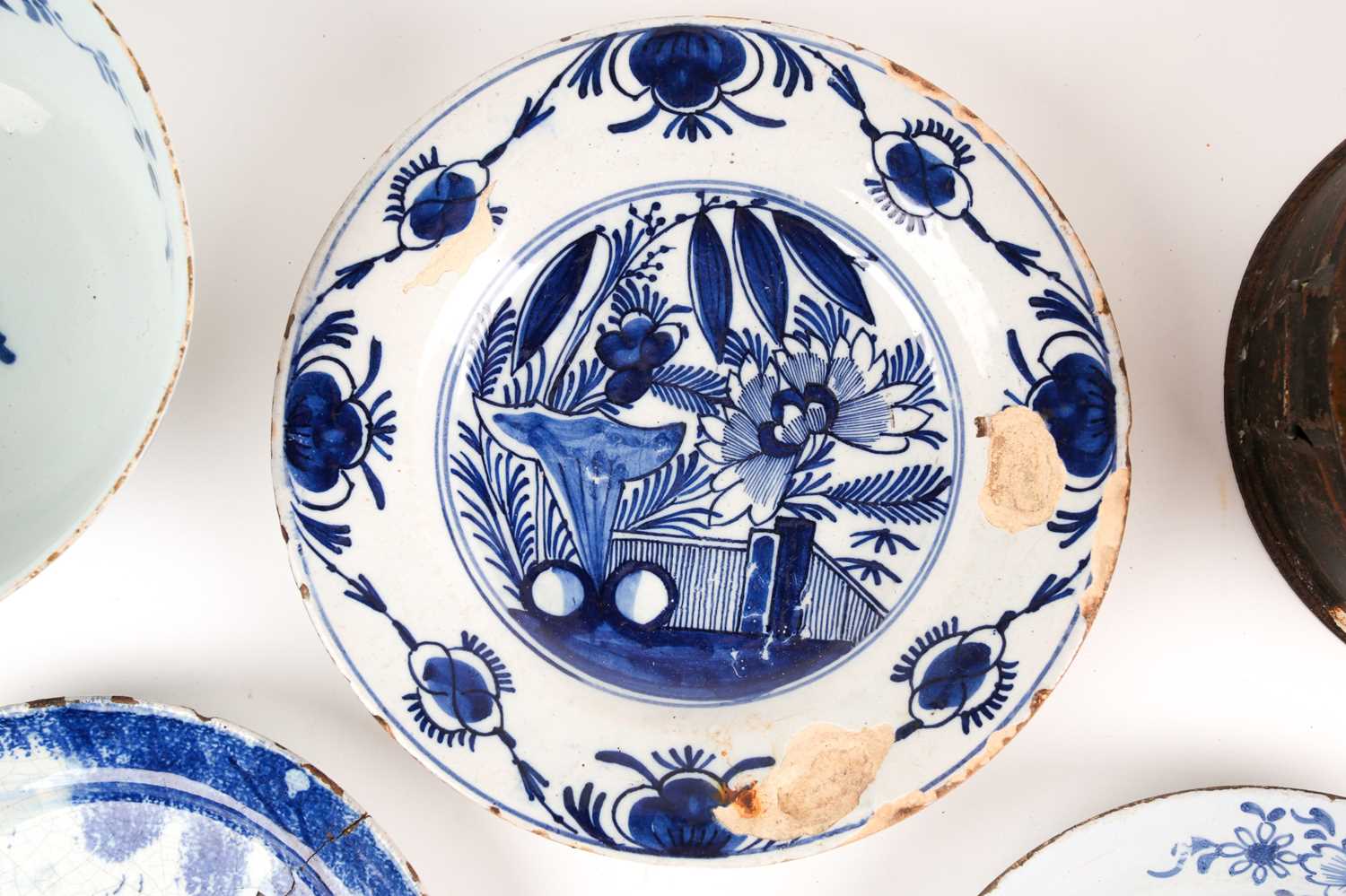 An 18th century delftware bowl and three plates, the bowl and a plate similarly decorated, painted - Image 4 of 7