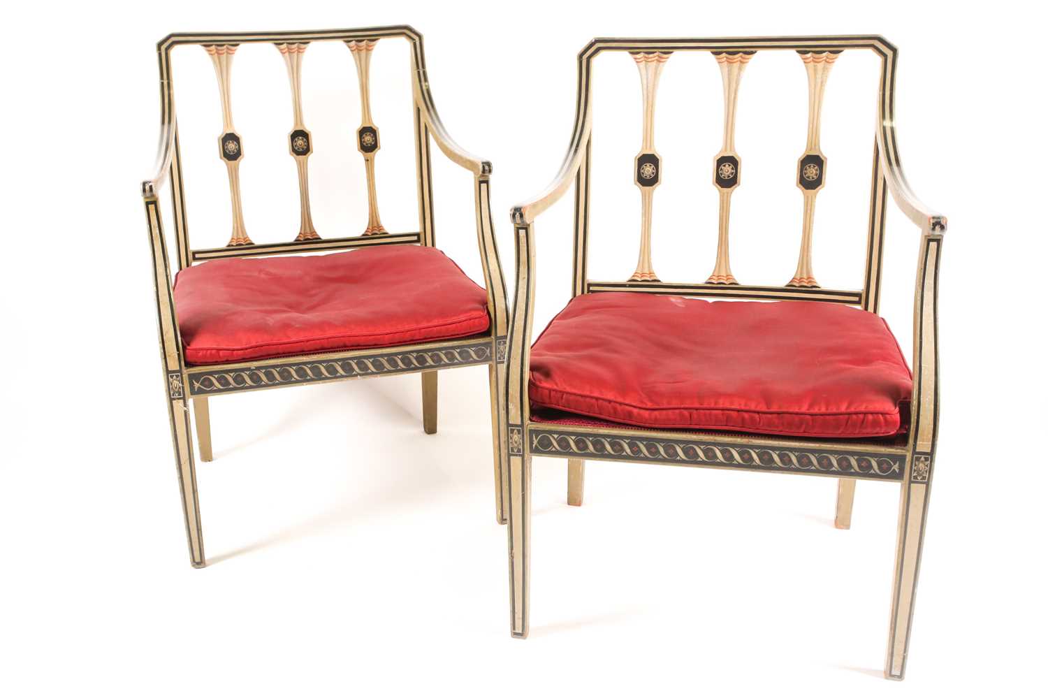 A pair of Sheraton style pale green painted open arm elbow chairs. With trompe l'oeil faux carved