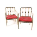 A pair of Sheraton style pale green painted open arm elbow chairs. With trompe l'oeil faux carved