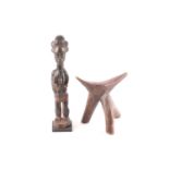 A Baule colon standing female figure, Ivory Coast, with multi lobed coiffure and with facial and
