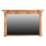 A Regency inverted breakfront carved wood and gilt gesso wall mirror. With lotus capped split