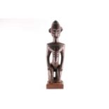 A Baule kneeling female figure, Blolo Bla, Ivory Coast, a linear carved coiffure, the face and