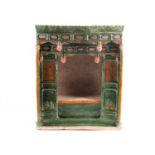 A Chinese pottery Sancai glazed shrine, late Ming, modelled as a temple, with scroll pediment