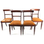 A set of four William IV figured rosewood dining chairs with plain broad cresting rails over drop-in