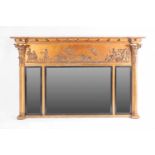 An early 19th century inverted breakfront carved wood and gilt gesso triple-section overmantle