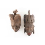 Two Ibo/Igbo Agbogho Mmwo masks, Nigeria, each with bird surmount, one with double arched coiffure