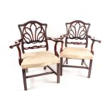 A pair of probably American "Chippendale Style" mahogany open arm elbow chairs with a laurel