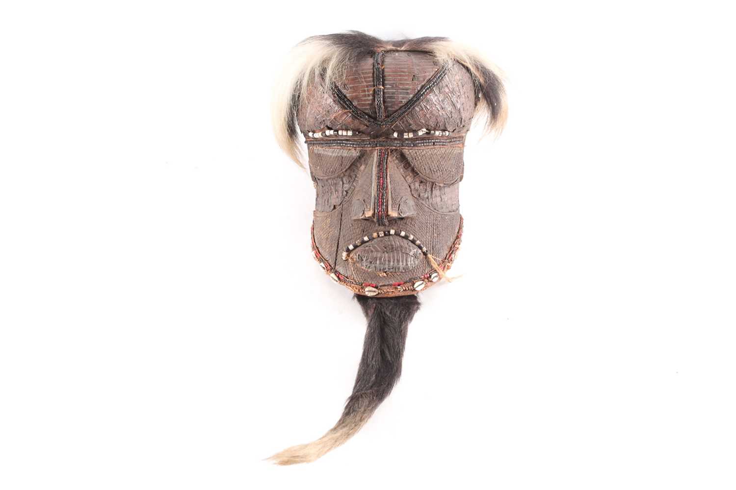 A Kuba Bwoom mask, Democratic Republic of Congo, the headdress of ox hide, carved throughout with