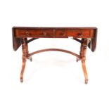A Regency brass inlaid mahogany two flap sofa table. Fitted two frieze drawers. On "Solomonic"