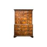 A George I figured walnut chest on chest fitted with eight "book matched" and "herringbone banded