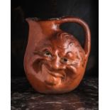 A Martin Brothers large double-sided stoneware face jug, dated 1899, modelled in relief to both