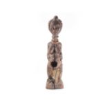 An Ambete standing female reliquary figure, Gabon, with linear coiffure, traces of red pigment to
