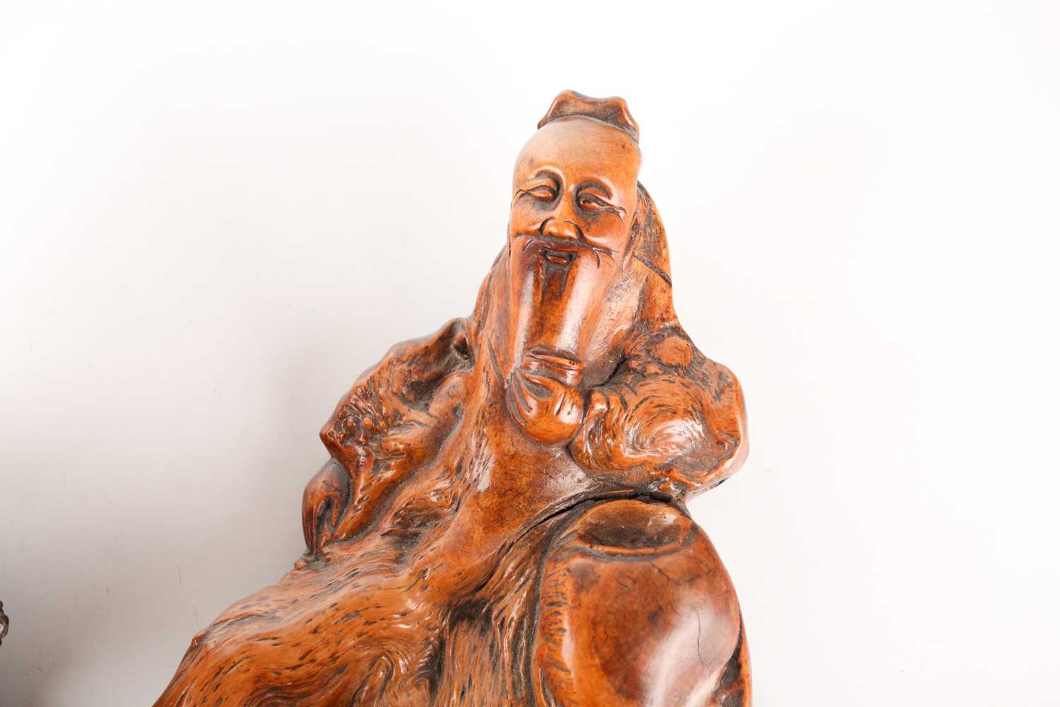 A Chinese root carving of a drunken scholar, Qing, 19th century, carved holding a cup whilst resting - Image 2 of 5