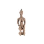 A Baule seated maternity figure, Ivory Coast, with linear and chevron coiffure, scarifications
