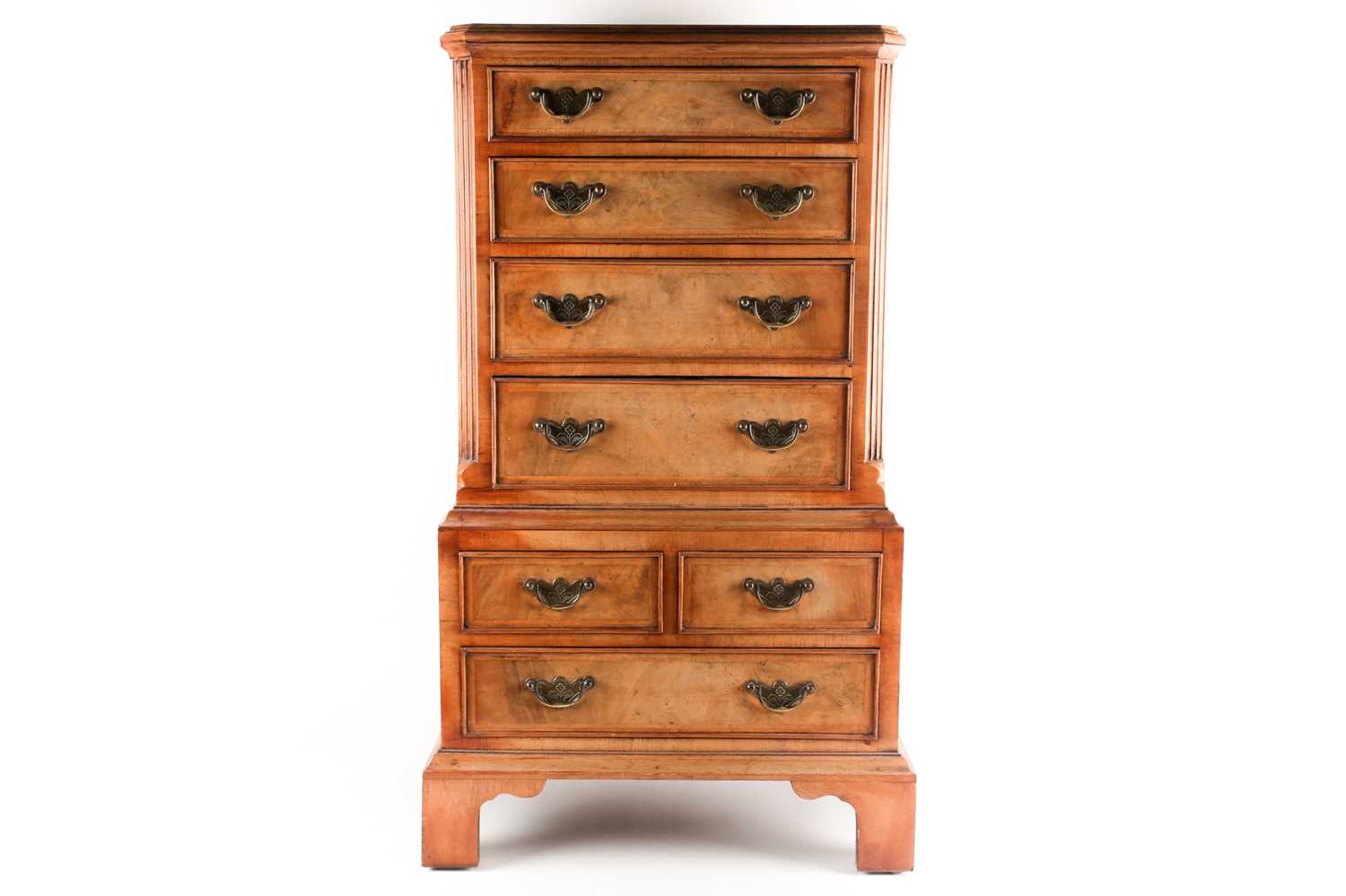 A George II style miniature walnut chest on chest with canted upper section fitted four long drawers