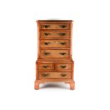 A George II style miniature walnut chest on chest with canted upper section fitted four long drawers