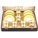 A set of six Aynsley bone china silver-mounted coffee cans and saucers, the two-tone yellow and