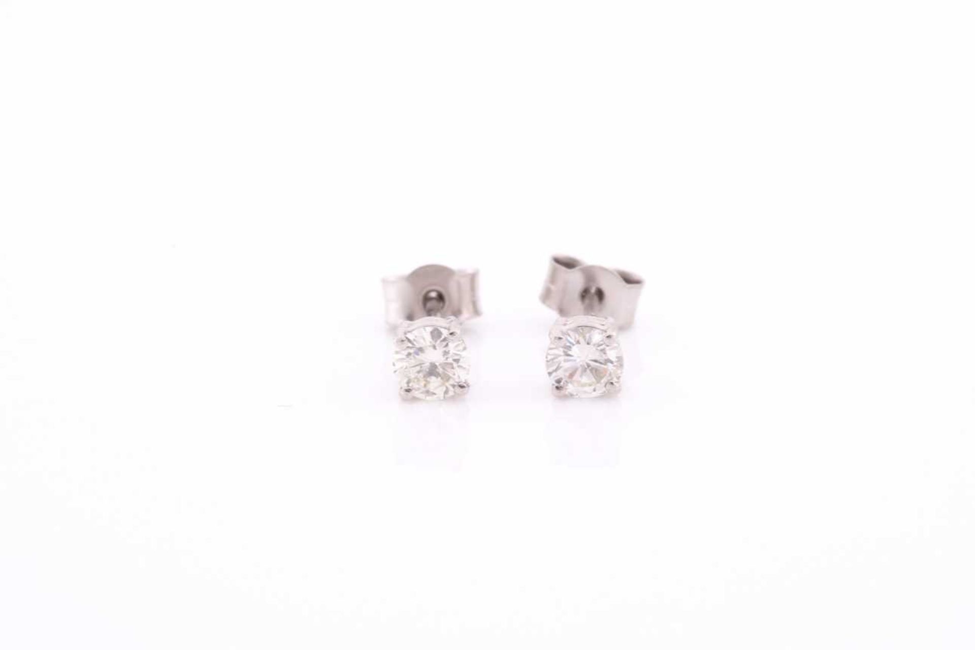 A pair of platinum and diamond earrings, the round brilliant-cut diamonds of approximately 0.67 - Image 2 of 4