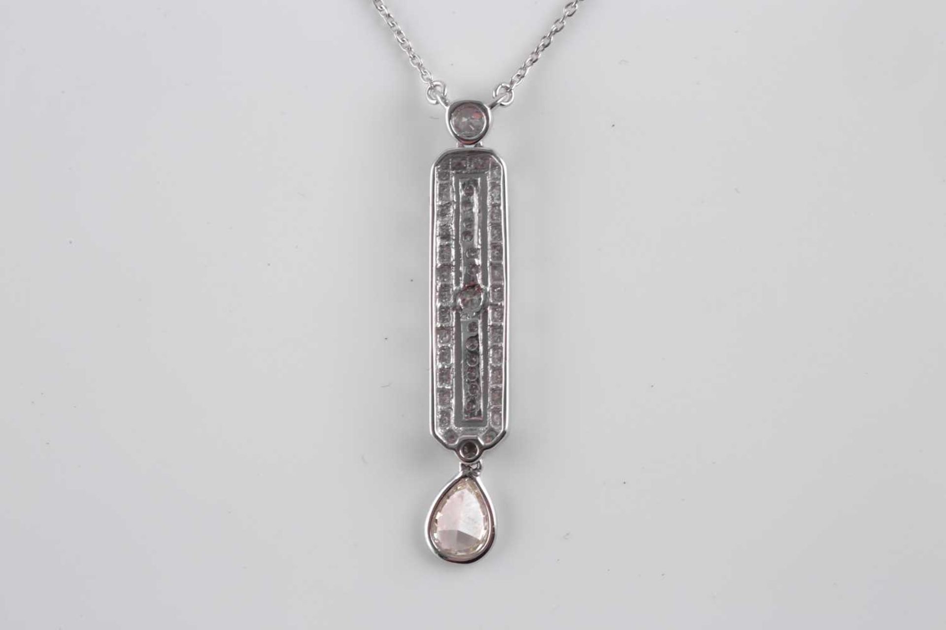 An 18ct white gold and diamond drop pendant, in the Art Deco style, set with a mixed pear-cut - Image 5 of 5