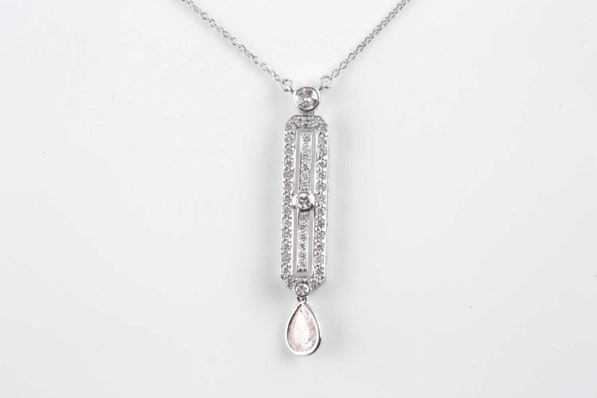 An 18ct white gold and diamond drop pendant, in the Art Deco style, set with a mixed pear-cut