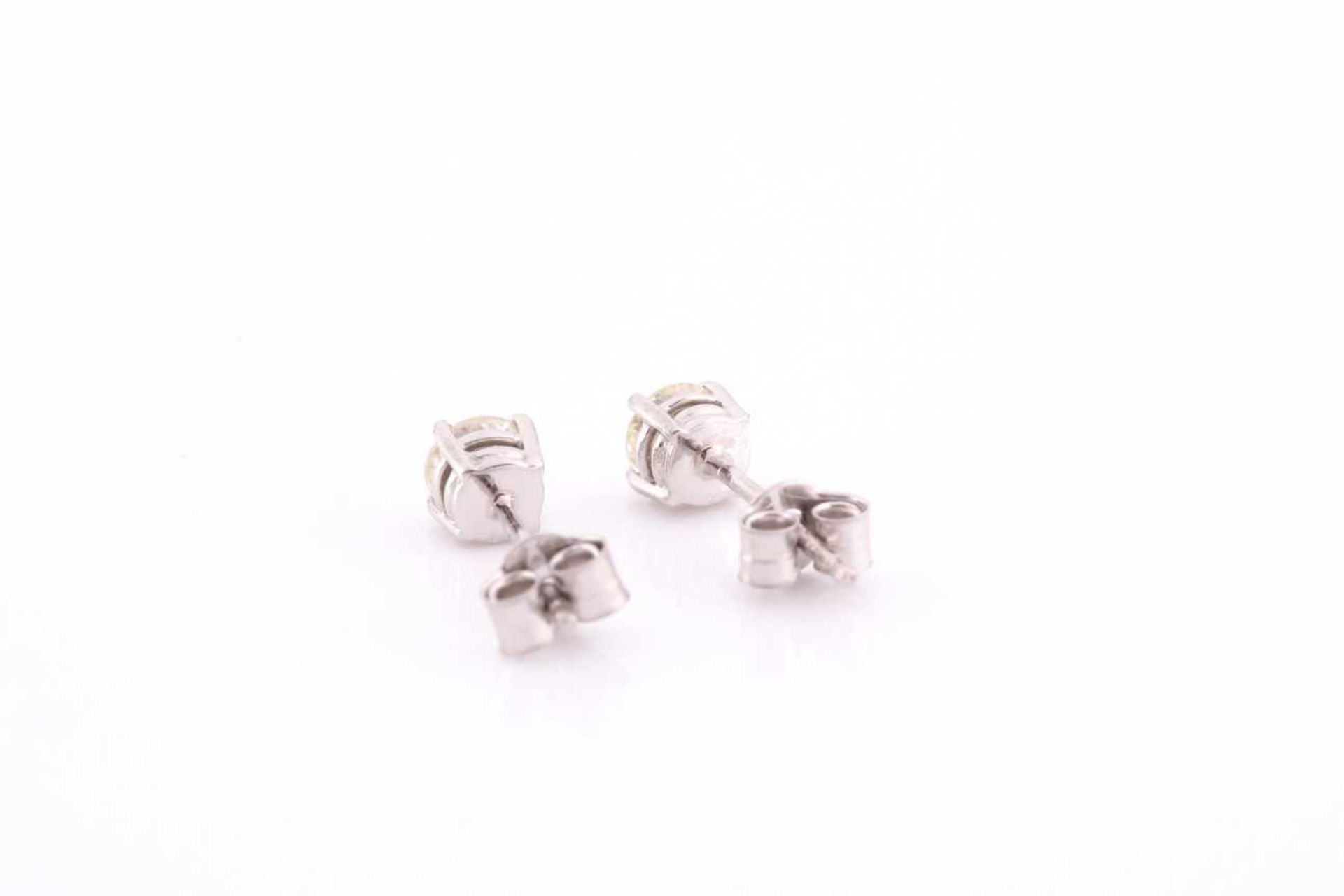 A pair of platinum and diamond earrings, the round brilliant-cut diamonds of approximately 0.67 - Image 3 of 4