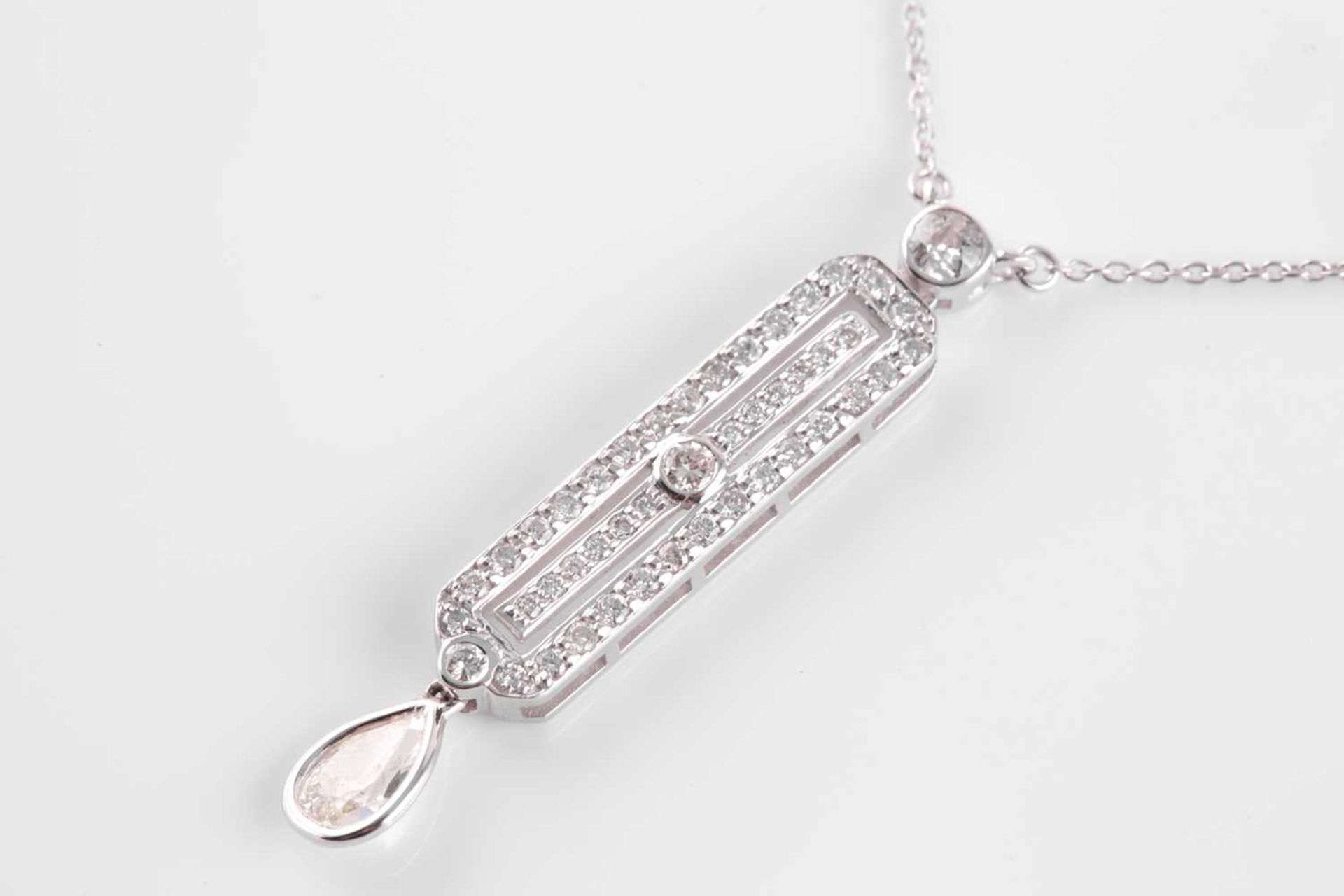An 18ct white gold and diamond drop pendant, in the Art Deco style, set with a mixed pear-cut - Image 4 of 5