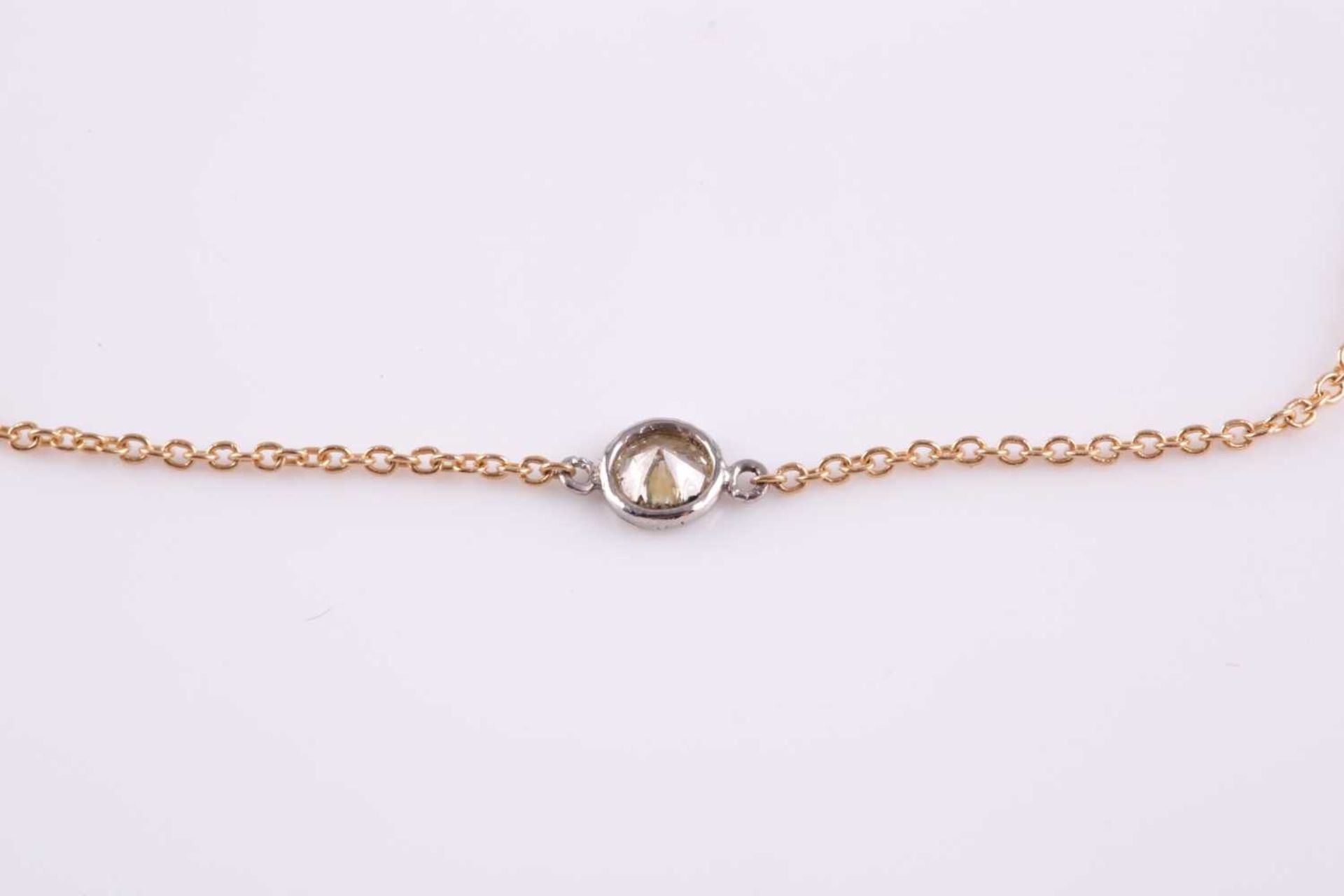 An 18ct yellow gold and diamond necklace, the chain set with a collet-mounted round brilliant-cut - Image 2 of 2