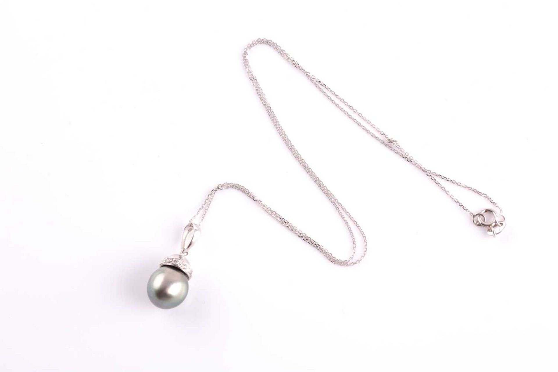 A diamond and grey pearl pendant, the pearl approximately 9.7 mm wide, beneath a diamond-set