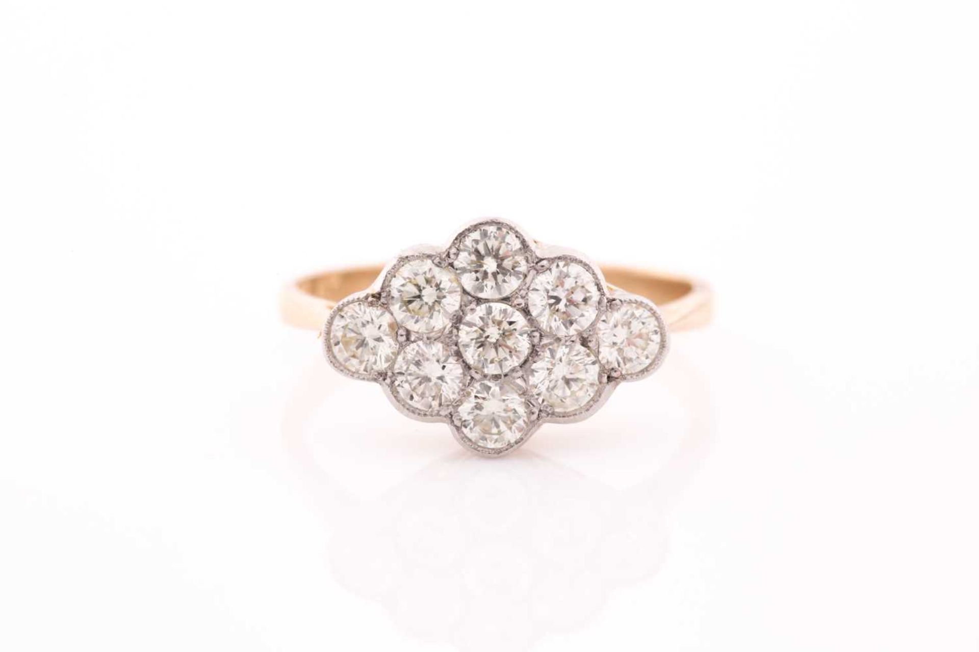 An 18ct yellow gold and diamond ring, set with a cluster of nine round brilliant-cut diamonds of