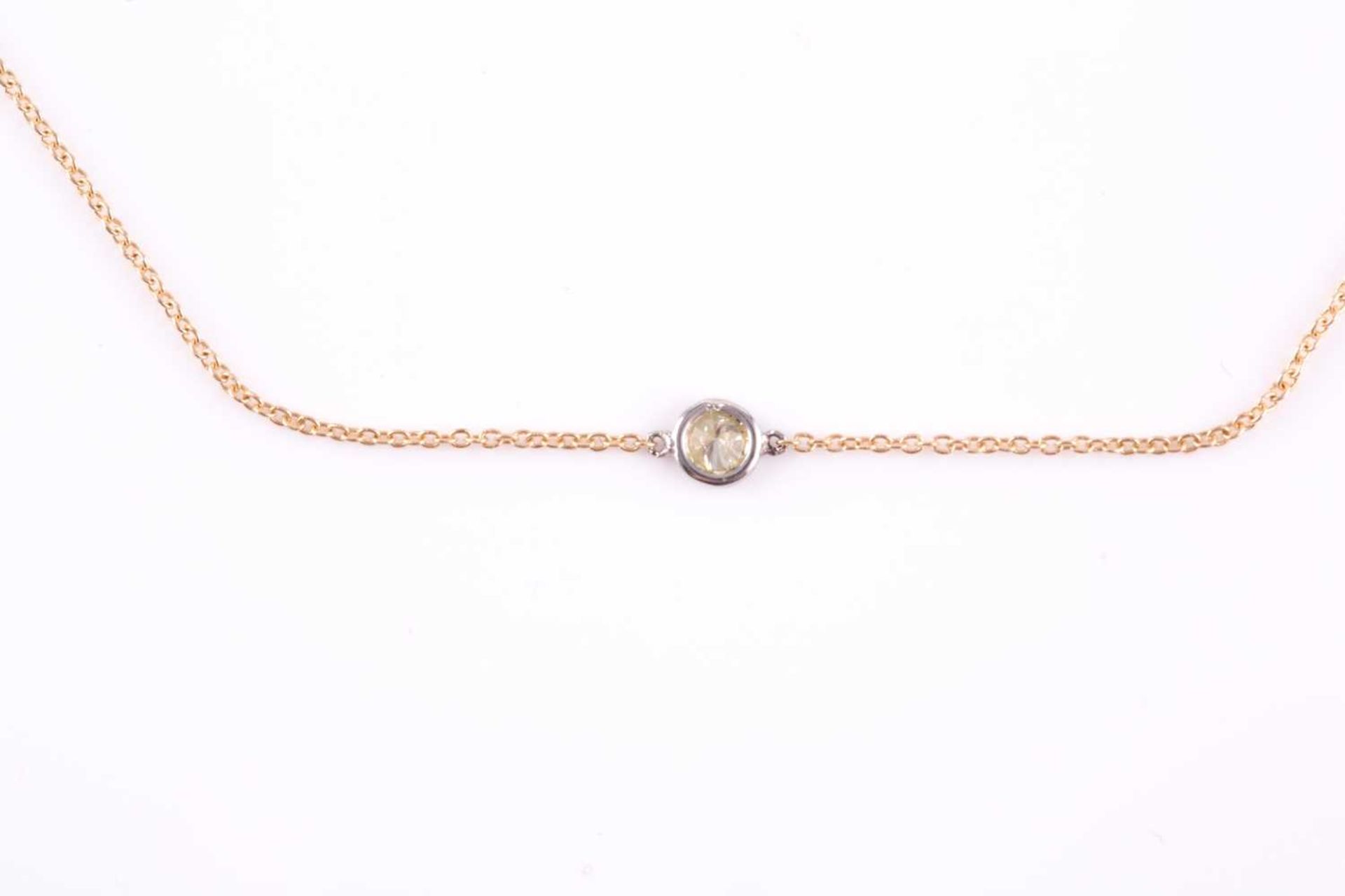 An 18ct yellow gold and diamond necklace, the chain set with a collet-mounted round brilliant-cut - Image 2 of 3
