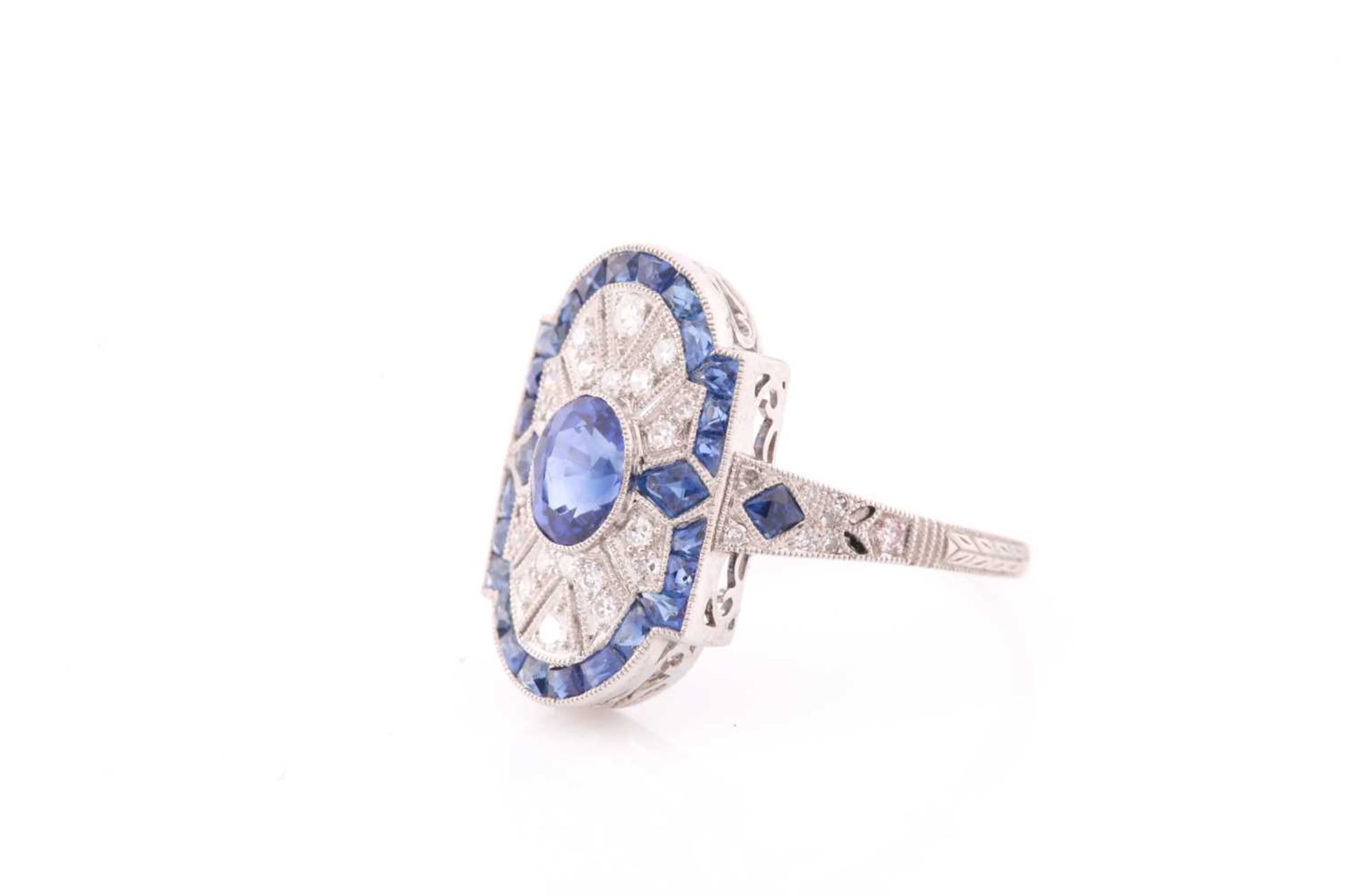 A platinum, diamond, and sapphire plaque ring, in the Art Deco style, centred with a mixed oval- - Image 2 of 4