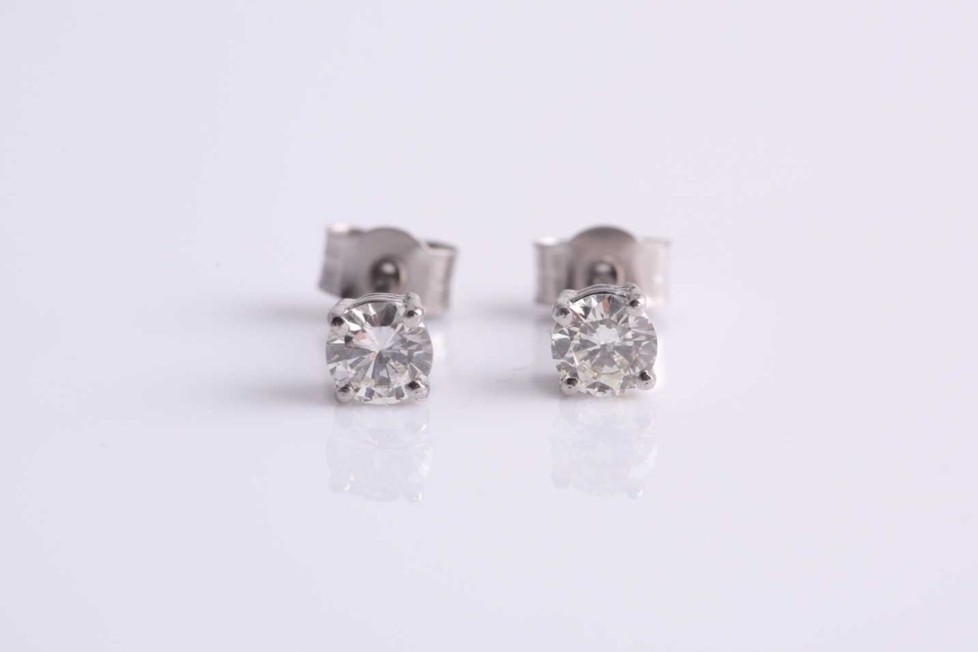 A pair of platinum and diamond ear studs, the round brilliant-cut diamonds of approximately 0.45