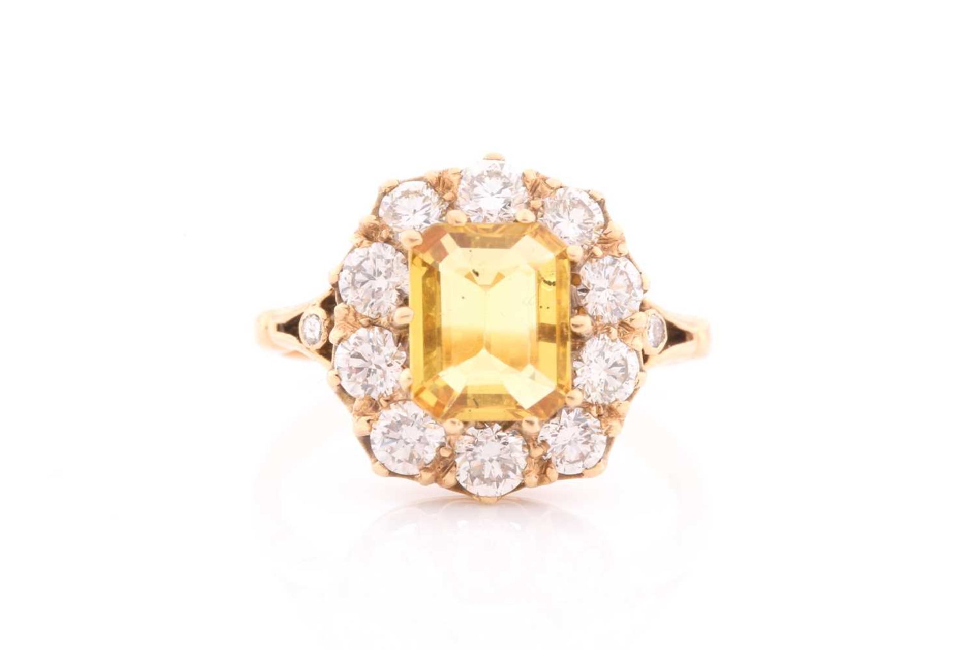 An 18ct yellow gold, diamond, and yellow sapphire dress ring, set with an emerald-cut sapphire of