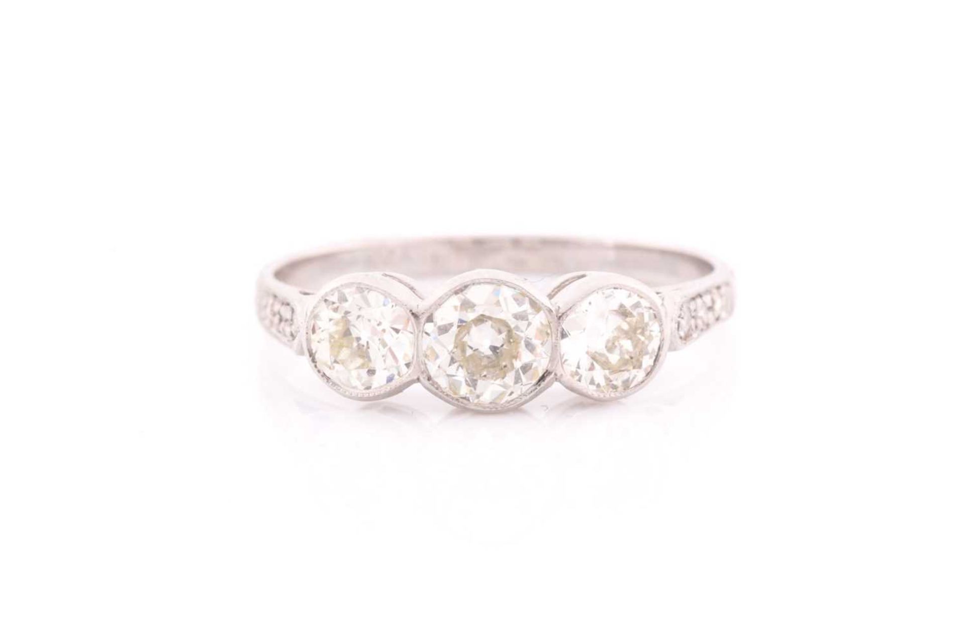 A platinum and diamond ring, collet-set with three old round-cut diamonds of approximately 1.35