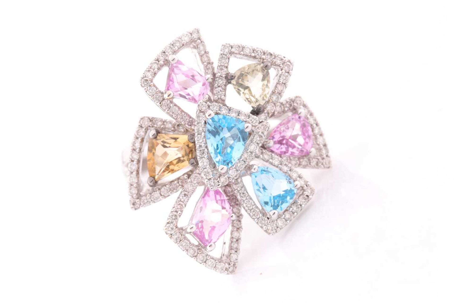 An 18ct white gold, diamond, and multi-coloured topaz ring of geometric floral form, the openwork