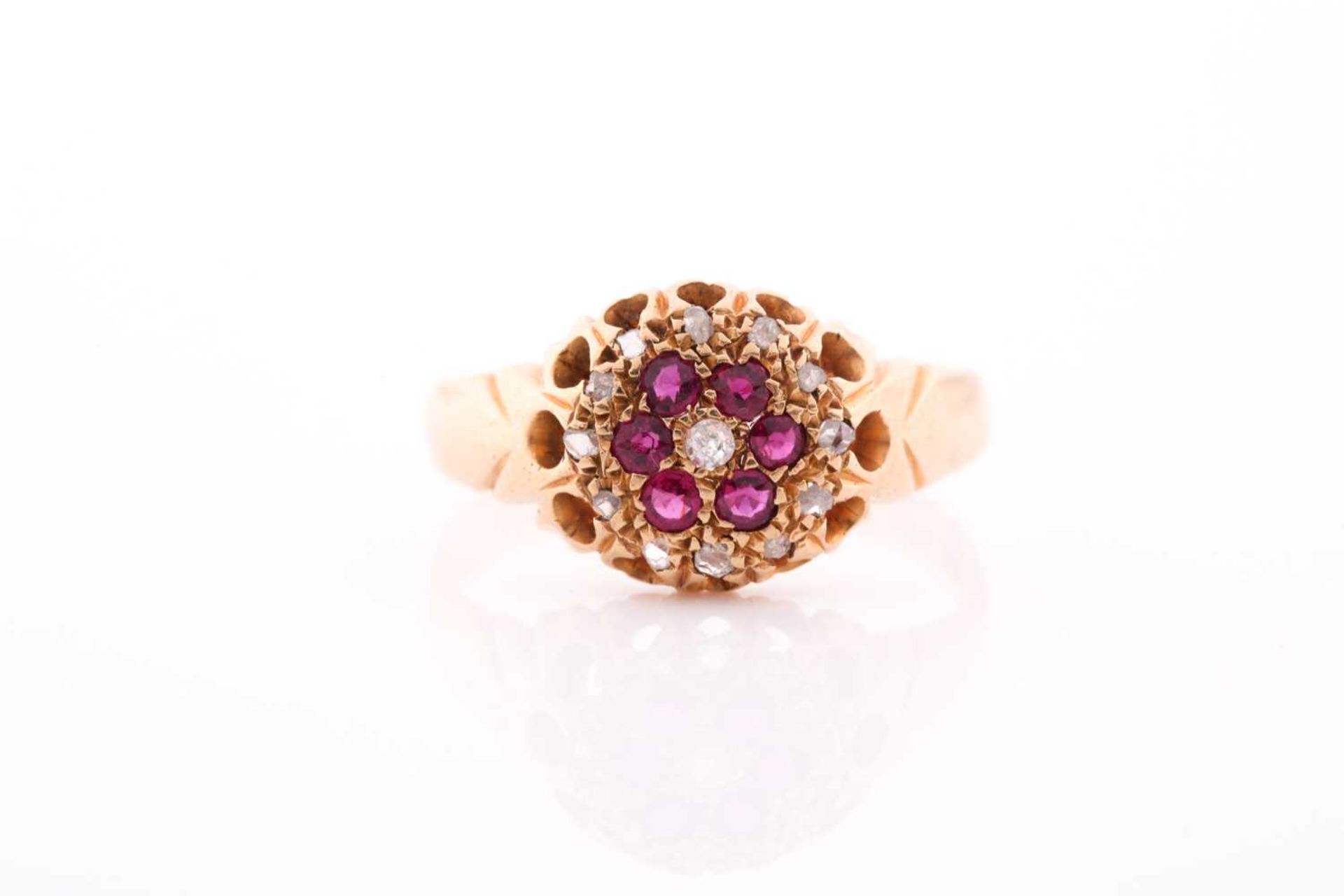An 18ct yellow gold, diamond, and ruby floral cluster ring, the claw-raised mount pave-set with