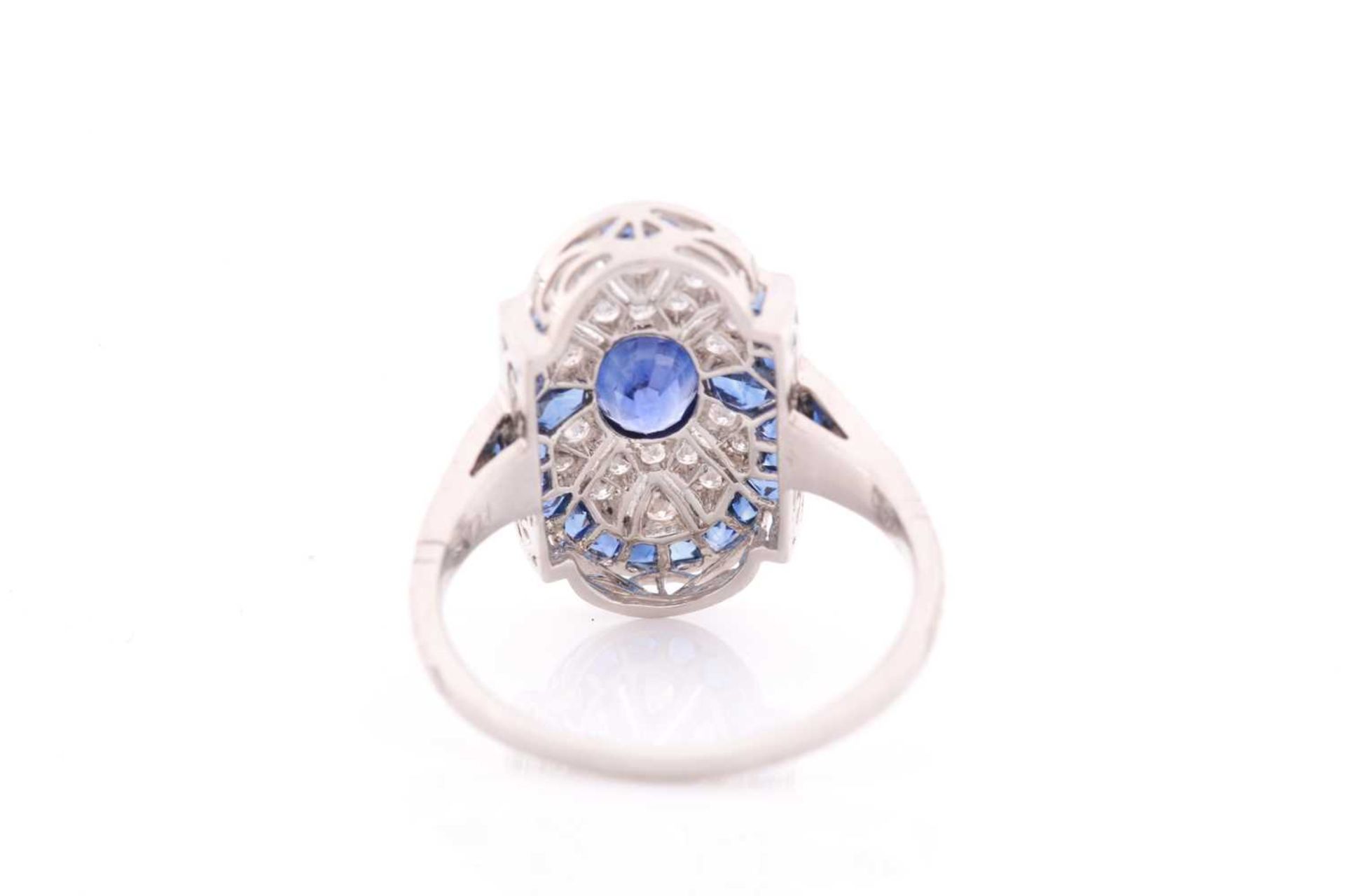 A platinum, diamond, and sapphire plaque ring, in the Art Deco style, centred with a mixed oval- - Image 4 of 4