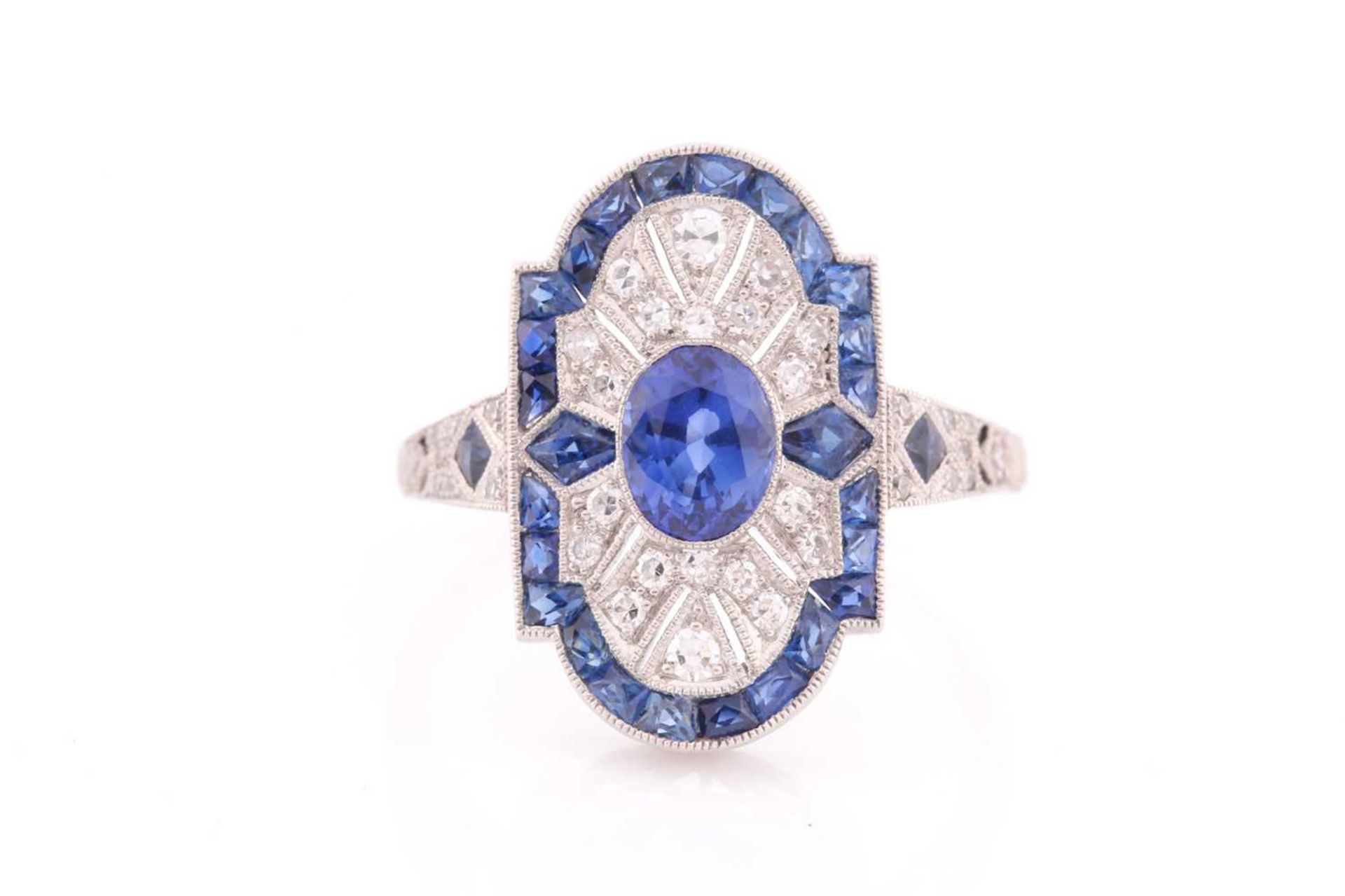 A platinum, diamond, and sapphire plaque ring, in the Art Deco style, centred with a mixed oval-