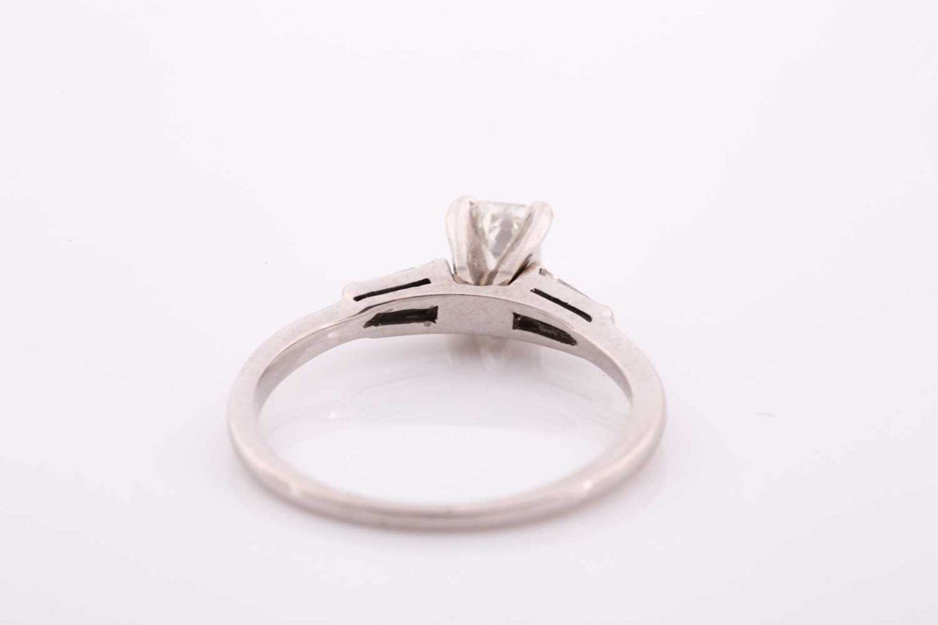 An 18ct white gold and diamond ring, set with an emerald-cut diamond of approximately 0.60 carats, - Image 4 of 4