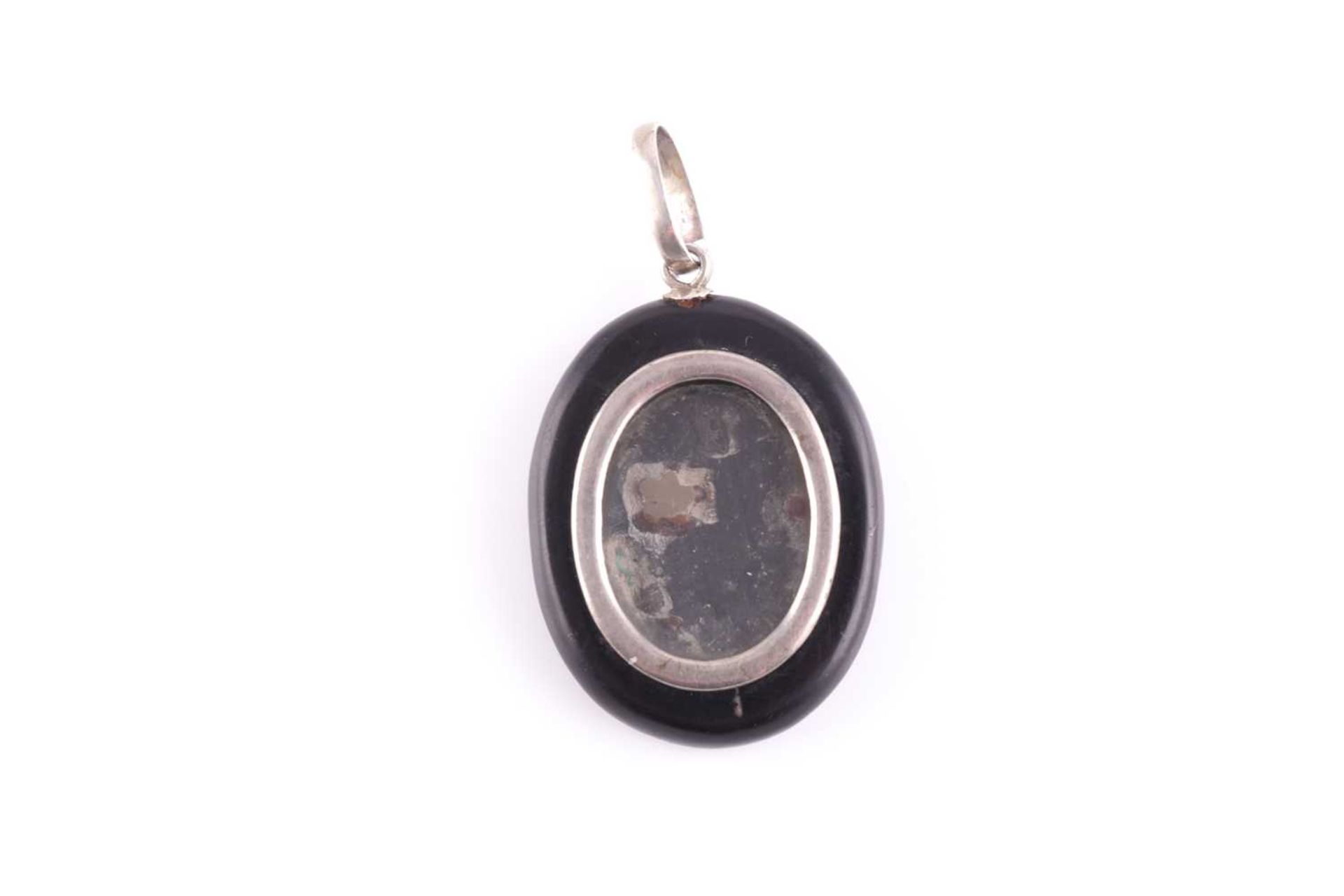 A silver and black hardstone pendant locket, the back inset with a pietra dura design of a flower - Image 2 of 2