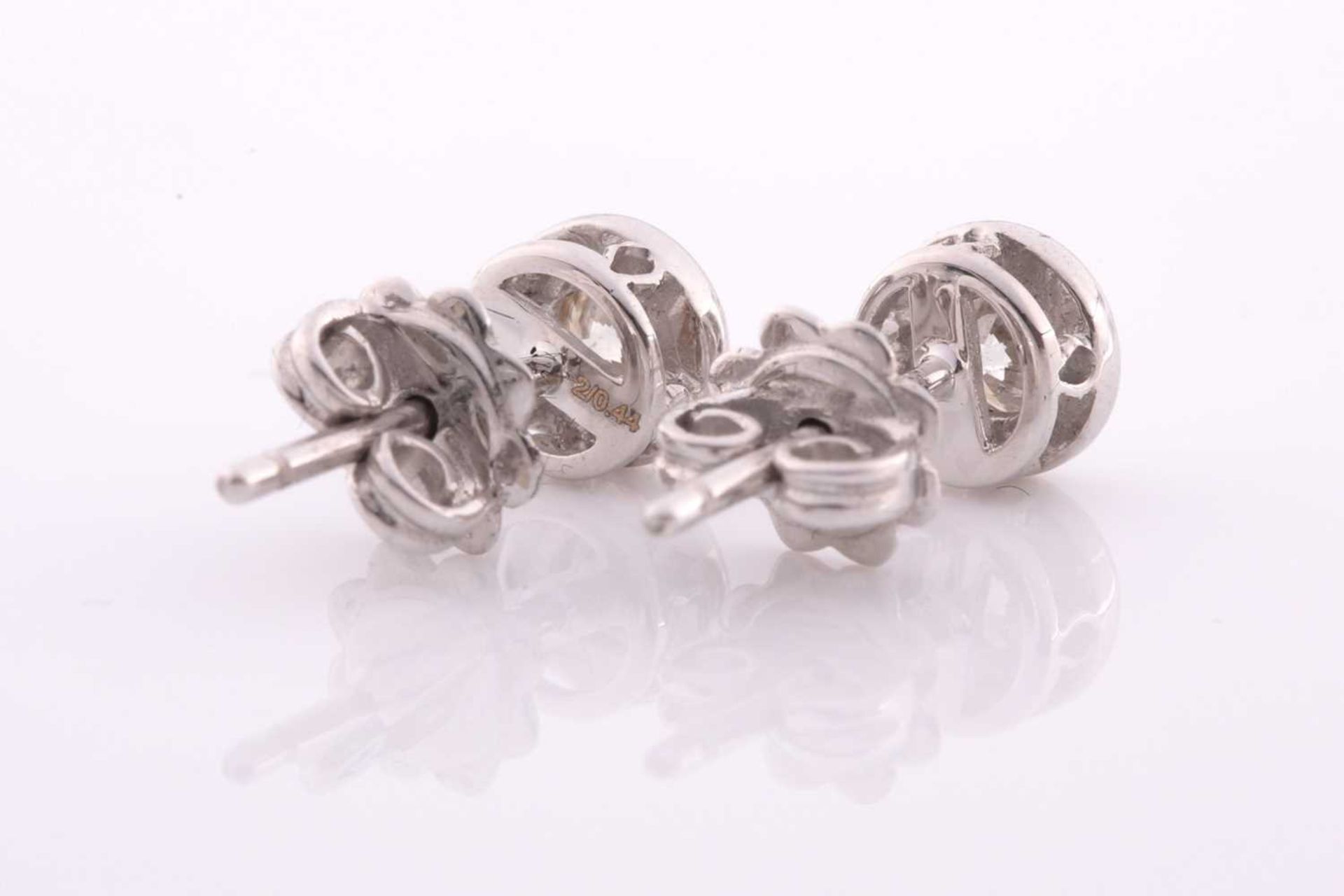 A pair of collet-set diamond solitaire ear studs, set with round brilliant-cut diamonds of - Image 2 of 2
