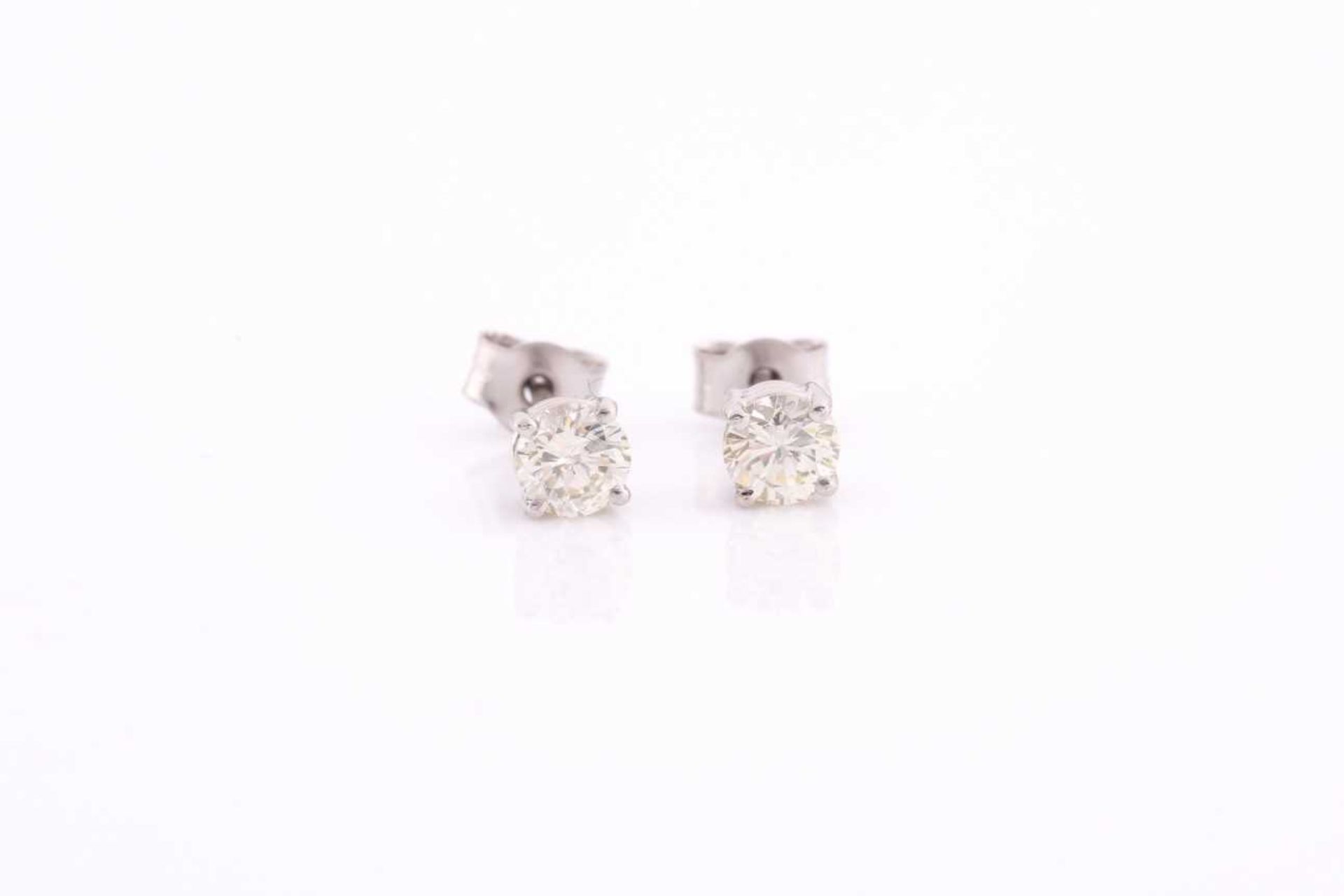 A pair of platinum and diamond earrings, the round brilliant-cut diamonds of approximately 0.67